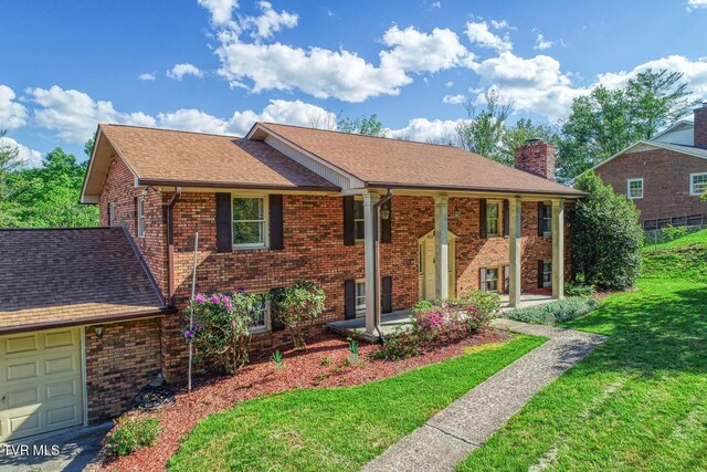 2653 Suffolk St, Kingsport, TN 37660 - view of front facade with a chimney, a front lawn, brick siding, and a shingled roof