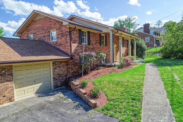 2653 Suffolk St, Kingsport, TN 37660 - view of front of property featuring brick siding, a front lawn, asphalt driveway, an attached garage, and a chimney