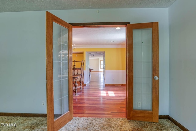 2653 Suffolk St, Kingsport, TN 37660 - hall with french doors, baseboards, ornamental molding, a textured ceiling, and carpet flooring