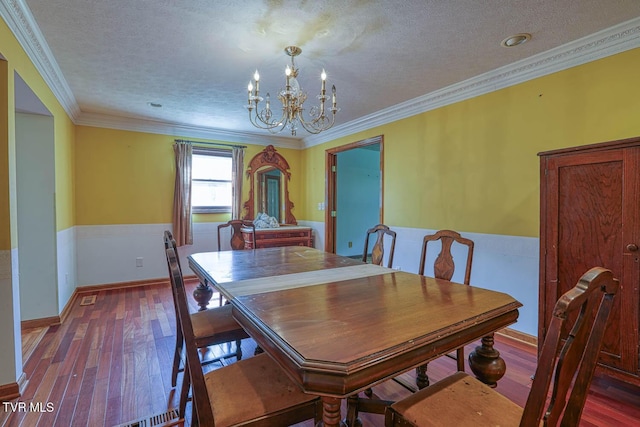 2653 Suffolk St, Kingsport, TN 37660 - dining room featuring a chandelier, wood-type flooring, a textured ceiling, ornamental molding, and baseboards
