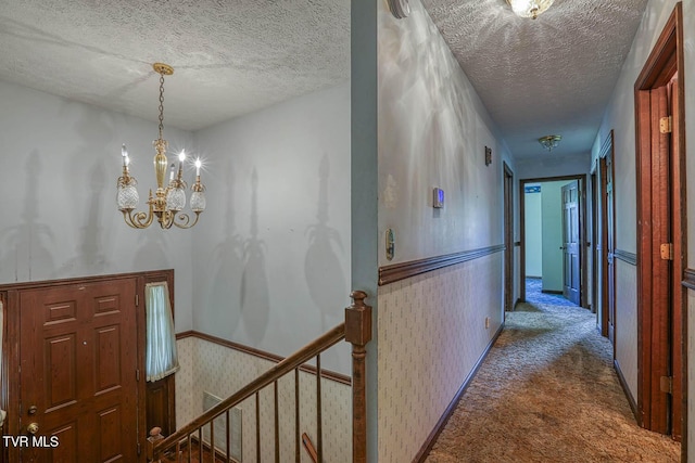 2653 Suffolk St, Kingsport, TN 37660 - corridor with an upstairs landing, carpet flooring, a textured ceiling, a chandelier, and a wainscoted wall