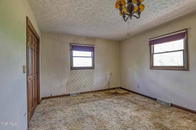 2653 Suffolk St, Kingsport, TN 37660 - carpeted spare room featuring a chandelier, baseboards, and a textured ceiling