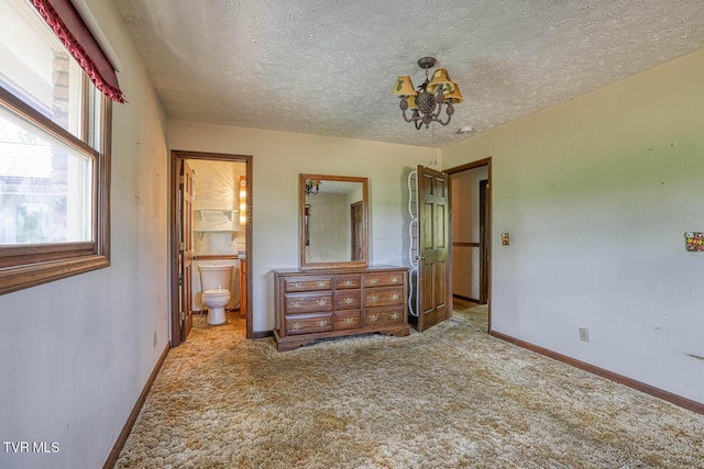 2653 Suffolk St, Kingsport, TN 37660 - unfurnished bedroom featuring a chandelier, carpet, baseboards, a textured ceiling, and ensuite bath