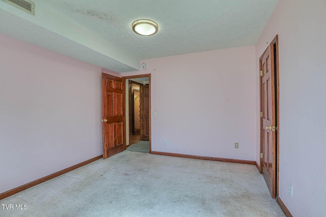 2653 Suffolk St, Kingsport, TN 37660 - spare room featuring a textured ceiling, carpet, and baseboards