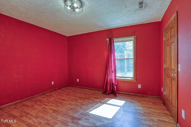 2653 Suffolk St, Kingsport, TN 37660 - empty room featuring wood finished floors, a textured ceiling, and baseboards