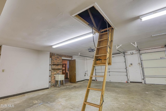 2653 Suffolk St, Kingsport, TN 37660 - garage featuring a garage door opener, baseboards, and a sink