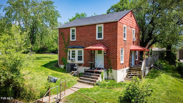 1689 Jefferson Ave, Kingsport, TN 37664 - view of front facade with a shingled roof, central AC, a front lawn, and brick siding