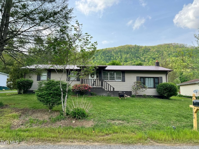 1220 2nd Ave, Big Stone Gap, VA 24219 - ranch-style house featuring a chimney, a view of trees, metal roof, and a front lawn
