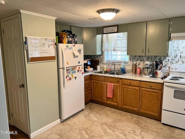 1220 2nd Ave, Big Stone Gap, VA 24219 - kitchen featuring a sink, brown cabinets, white appliances, and light countertops