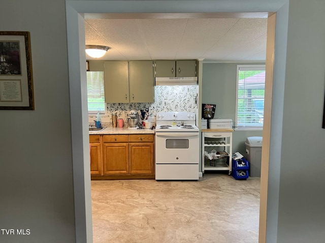1220 2nd Ave, Big Stone Gap, VA 24219 - kitchen with light countertops, brown cabinetry, tasteful backsplash, under cabinet range hood, and white electric range