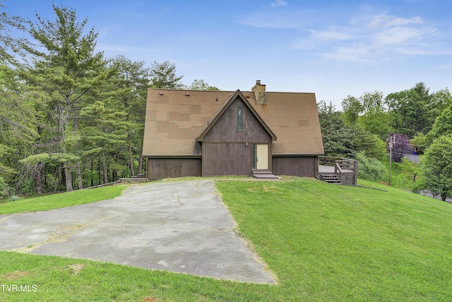 view of front of house with a front lawn, a chimney, and a deck