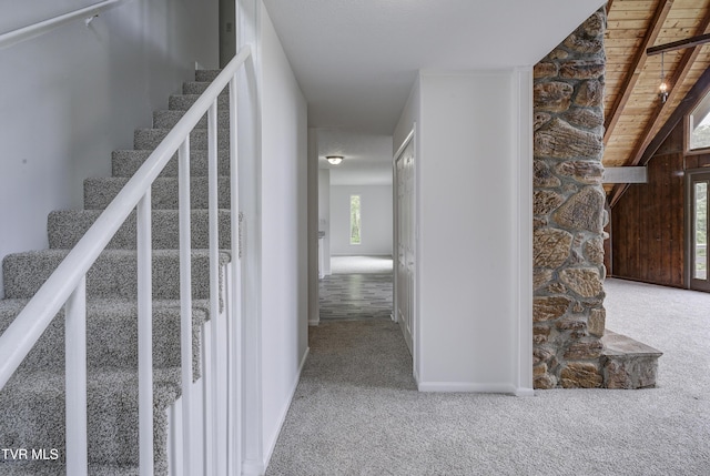stairway featuring carpet flooring and baseboards