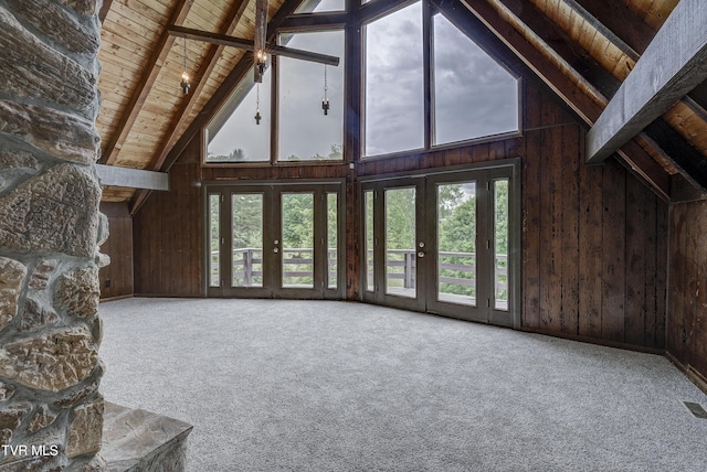 unfurnished living room with wood ceiling, wooden walls, beamed ceiling, high vaulted ceiling, and healthy amount of natural light