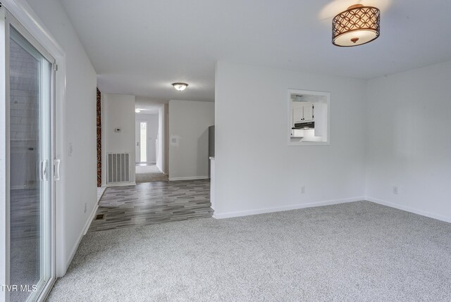 empty room with carpet floors and baseboards