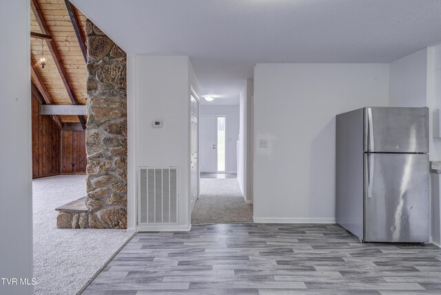 kitchen with freestanding refrigerator, wood finished floors, and baseboards