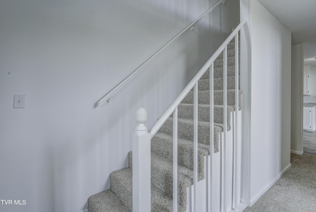 stairs with carpet floors and baseboards