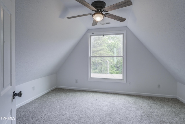 additional living space featuring vaulted ceiling, carpet, baseboards, and ceiling fan