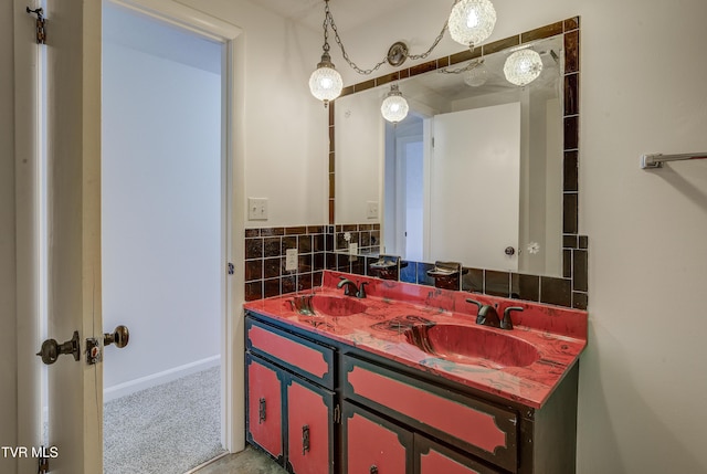 bathroom featuring double vanity and baseboards