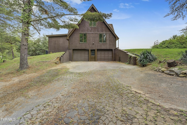 view of home's exterior featuring driveway and a garage