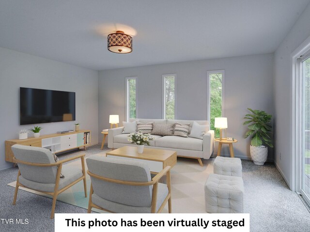 living area with plenty of natural light, carpet flooring, and baseboards