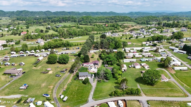 birds eye view of property with a mountain view and a wooded view