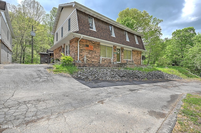3851 Helen Henderson Hwy, Davenport, VA 24239 - view of side of home with covered porch, brick siding, and a shingled roof