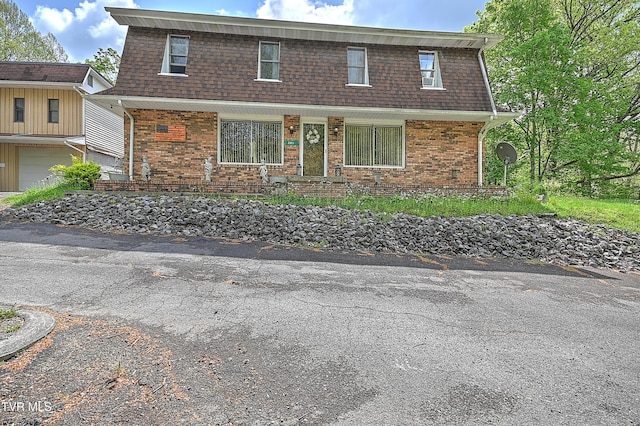 3851 Helen Henderson Hwy, Davenport, VA 24239 - view of front of home with brick siding, a shingled roof, a garage, and mansard roof