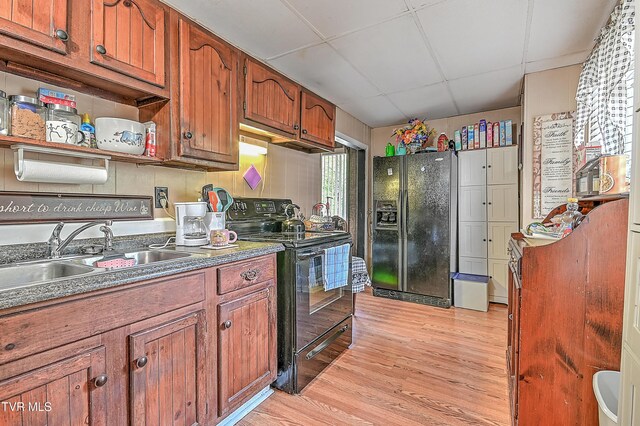 3851 Helen Henderson Hwy, Davenport, VA 24239 - kitchen with light wood-type flooring, a paneled ceiling, brown cabinets, a sink, and black appliances
