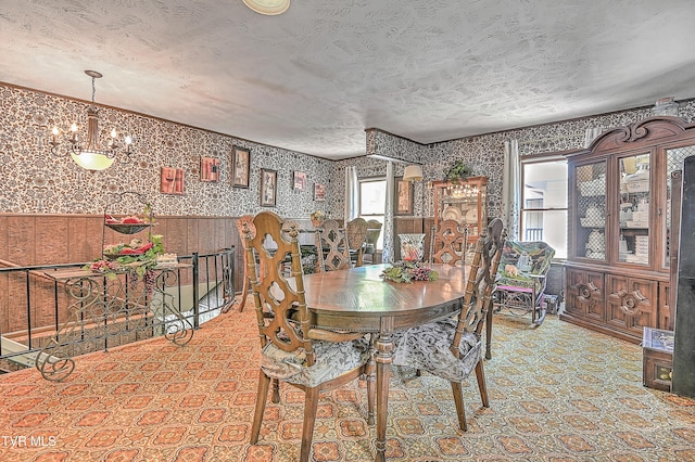 3851 Helen Henderson Hwy, Davenport, VA 24239 - dining area featuring a textured ceiling, wallpapered walls, an inviting chandelier, and a wainscoted wall