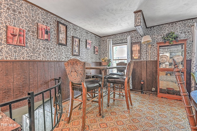 3851 Helen Henderson Hwy, Davenport, VA 24239 - dining space with ornamental molding, wainscoting, wallpapered walls, and a textured ceiling