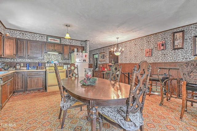 3851 Helen Henderson Hwy, Davenport, VA 24239 - dining space featuring wallpapered walls, a notable chandelier, ornamental molding, and a wainscoted wall