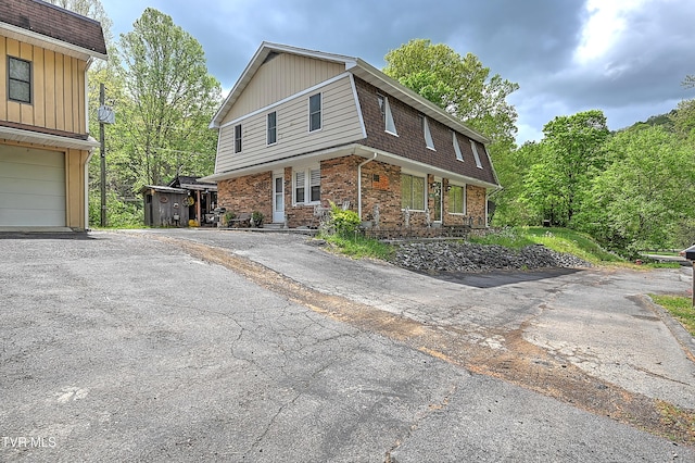 3851 Helen Henderson Hwy, Davenport, VA 24239 - view of property exterior featuring brick siding, an attached garage, roof with shingles, and aphalt driveway