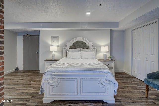 200 E Main St Unit 201, Johnson City, TN 37604 - bedroom with dark wood-type flooring, a closet, and a textured ceiling