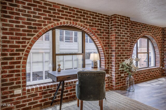 200 E Main St Unit 201, Johnson City, TN 37604 - office featuring brick wall, a textured ceiling, and wood-type flooring