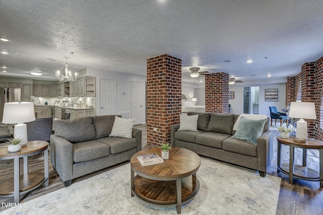 200 E Main St Unit 201, Johnson City, TN 37604 - living room featuring wood finished floors, a chandelier, a ceiling fan, a textured ceiling, and recessed lighting