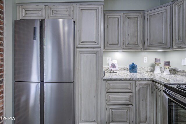 200 E Main St Unit 201, Johnson City, TN 37604 - kitchen featuring freestanding refrigerator, electric range oven, and light stone countertops