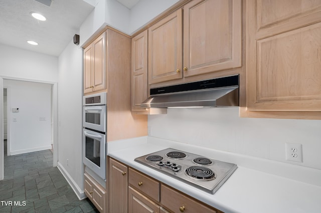 kitchen featuring light brown cabinetry, light countertops, stainless steel appliances, recessed lighting, and under cabinet range hood