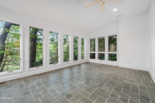 unfurnished sunroom with baseboards, recessed lighting, lofted ceiling, and stone finish floor
