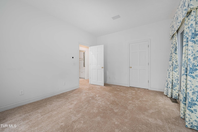 unfurnished bedroom with baseboards and carpet flooring