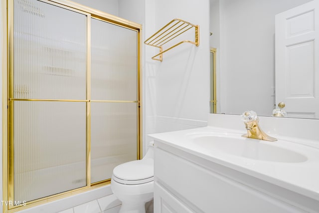 bathroom with vanity, tile patterned floors, toilet, and a shower stall
