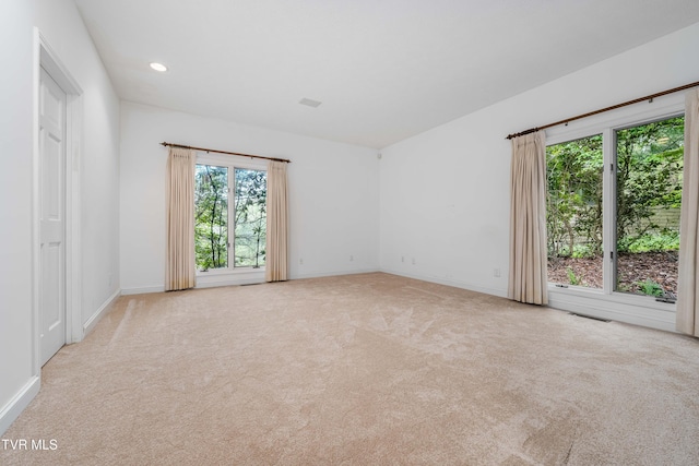 unfurnished room with carpet floors, recessed lighting, baseboards, and visible vents