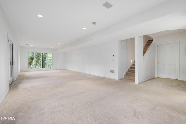 unfurnished living room with visible vents, stairs, baseboards, light carpet, and recessed lighting
