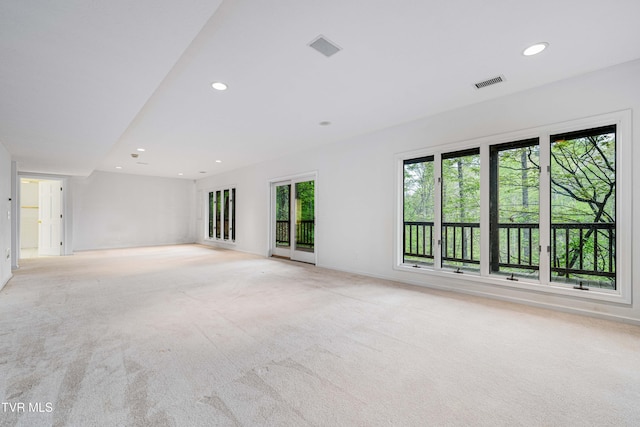 unfurnished room with recessed lighting, baseboards, visible vents, and light colored carpet