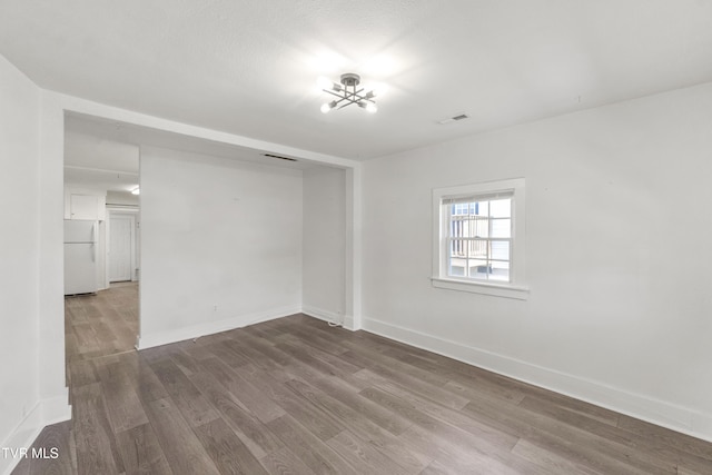 1607 E Millard St, Johnson City, TN 37601 - spare room with baseboards, visible vents, and wood finished floors