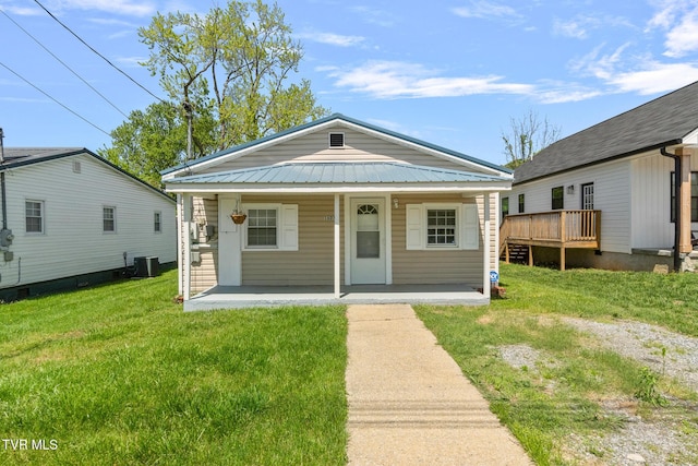 1607 E Millard St, Johnson City, TN 37601 - shotgun-style home featuring central AC unit, a front lawn, covered porch, and metal roof