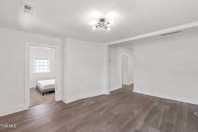 1607 E Millard St, Johnson City, TN 37601 - spare room featuring an inviting chandelier, baseboards, wood finished floors, and visible vents