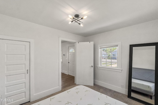 1607 E Millard St, Johnson City, TN 37601 - unfurnished bedroom featuring baseboards and a chandelier