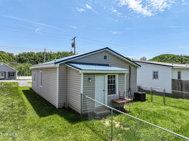 1607 E Millard St, Johnson City, TN 37601 - rear view of house with a lawn, fence, metal roof, and cooling unit