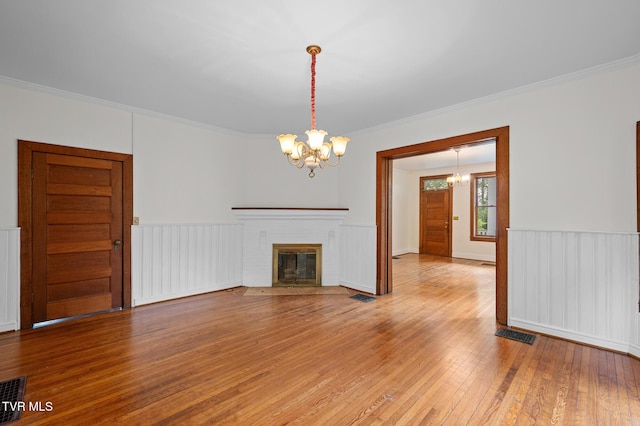243 NW Mason Pl, Abingdon, VA 24210 - unfurnished living room with crown molding, visible vents, hardwood / wood-style flooring, and a chandelier