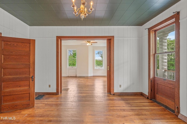 243 NW Mason Pl, Abingdon, VA 24210 - unfurnished dining area with wood-type flooring, baseboards, a notable chandelier, and visible vents